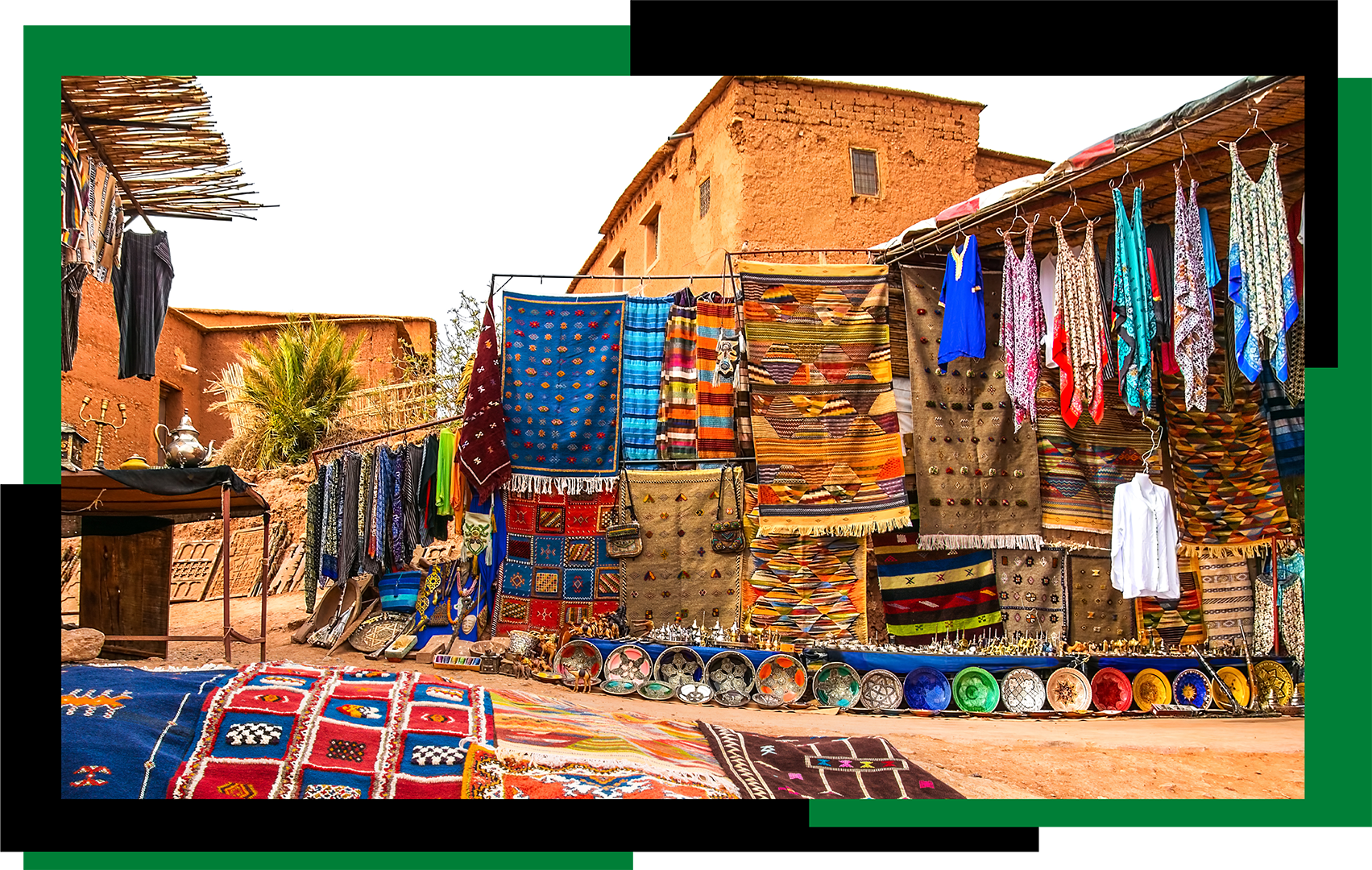 Dresses and mats hung on lines in an open air market Africa
